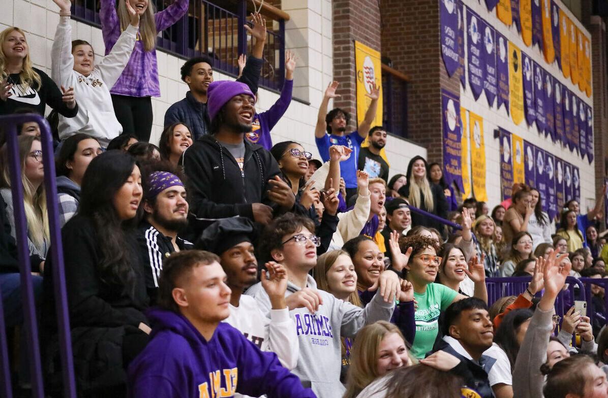 Students fill the bleachers as they cheer during Hoops Hysteria